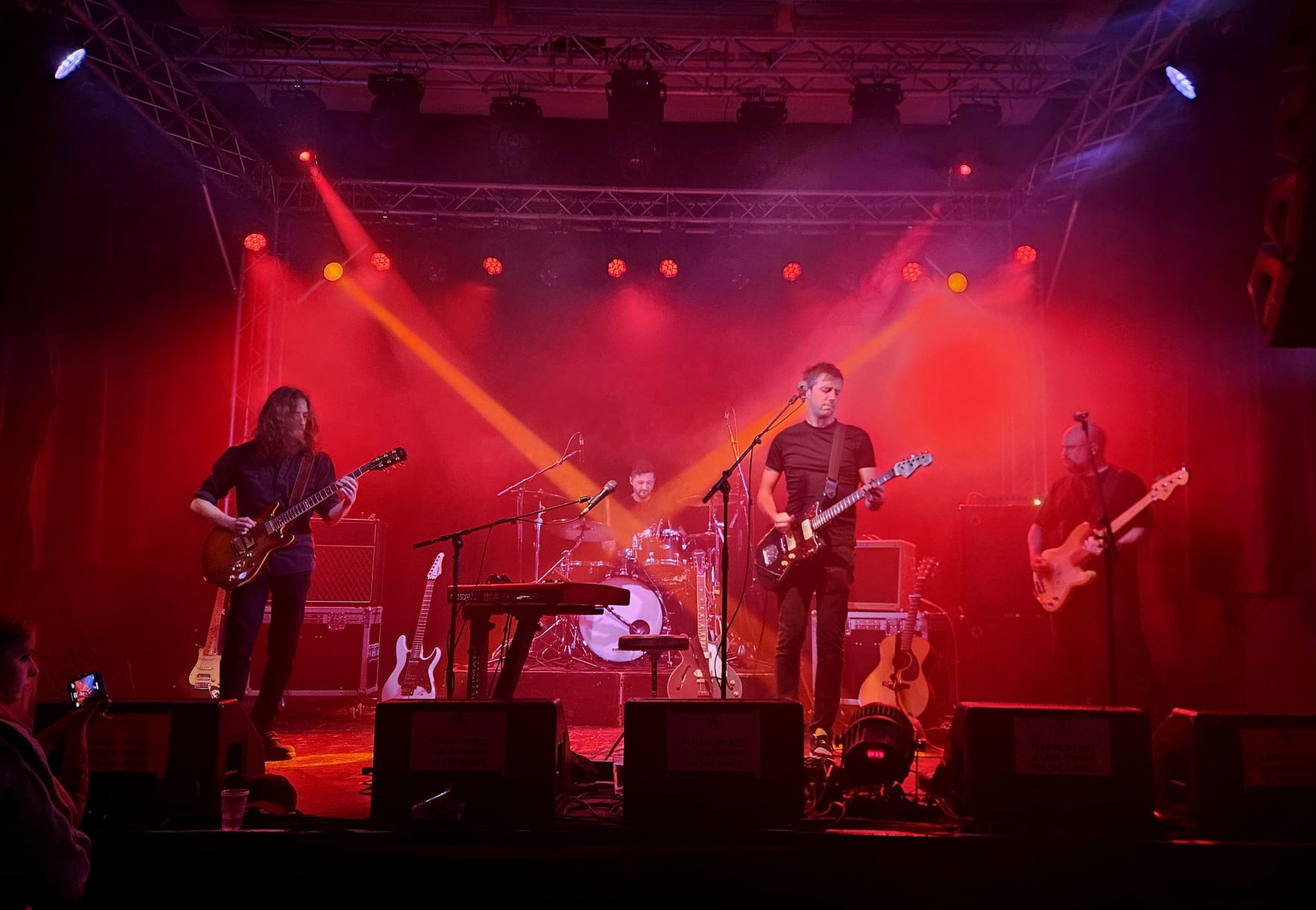 Francis performing live on stage — full band, dramatic lighting