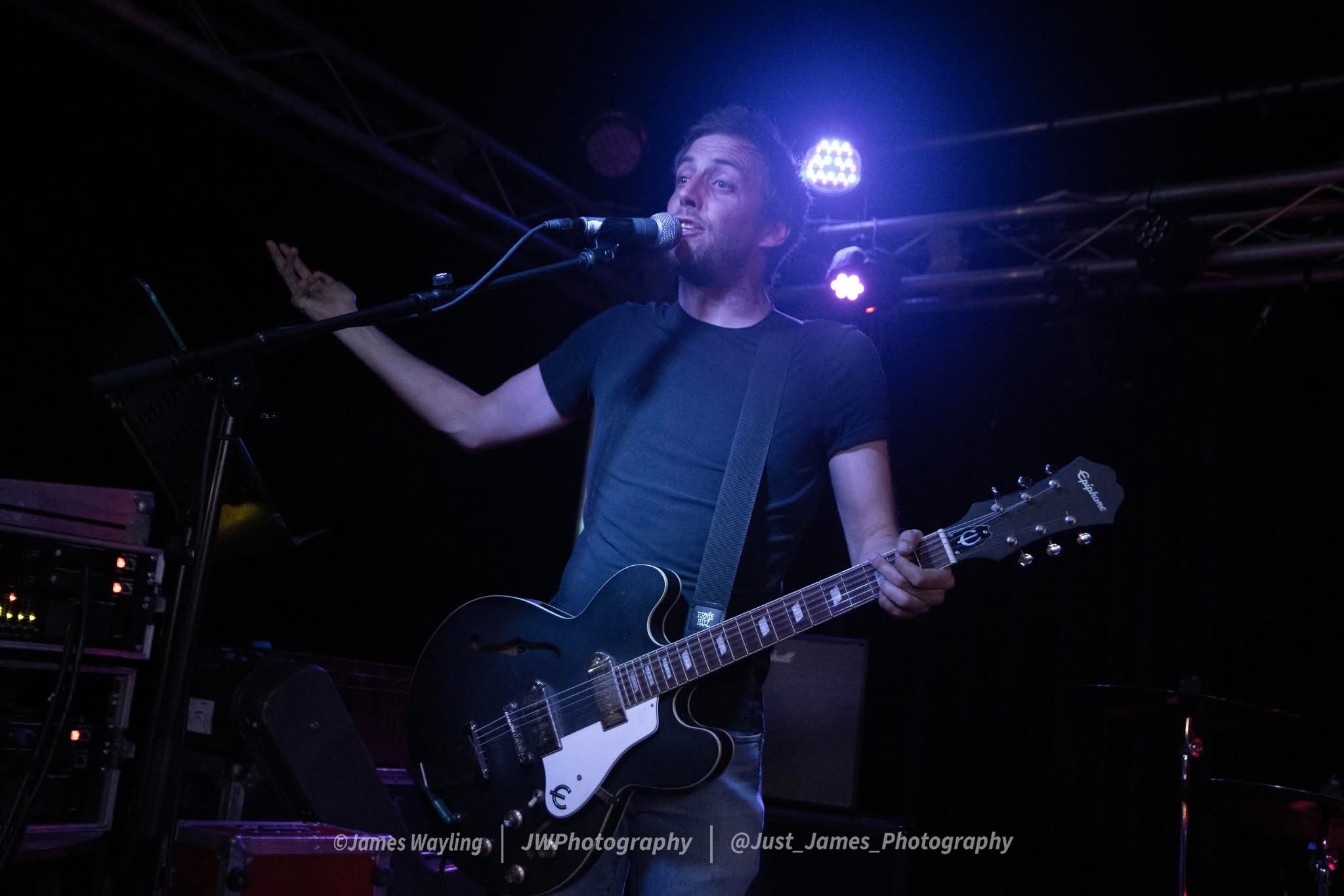 Francis vocalist and guitarist performing live — blue spotlight